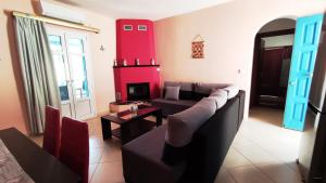 a living room with a couch and a tv at Orion Suite & Apartments in Donoussa