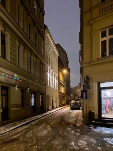 an empty street in a city at night at Wąska 5 Apartamenty in Wrocław