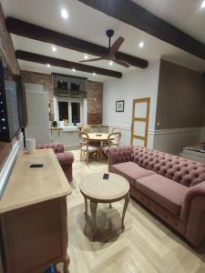 a living room with a couch and a table at Apartments PSD - Anny Łajming 1D in Słupsk
