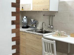 a kitchen with a sink and a counter top at Amaré Guest House in Naples