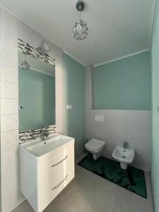a bathroom with a sink and a toilet at Apartament Janusza in Gronków