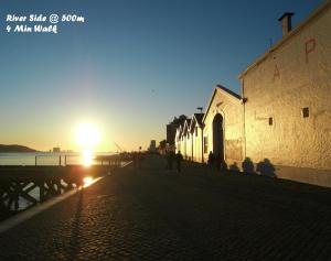a group of people walking down a street at sunset at Apartamento Embaixador Mateus in Lisbon