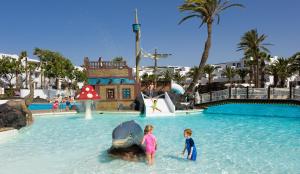 two children playing in the water at a water park at H10 Suites Lanzarote Gardens in Costa Teguise