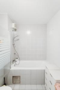 a white bathroom with a shower and a toilet at Peaceful Little Retreat, spacious free garage park in Ljubljana