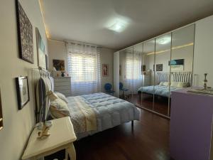 a bedroom with a bed and a mirror at Camera Palazzoni in Perugia