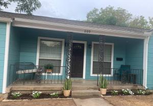 a blue house with a front porch with plants at *3 blocks from AT&T Stadium* 2 bedroom-sleeps 6 in Arlington