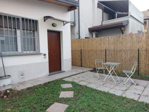 twee stoelen en een tafel voor een huis bij Smile Home! Graziosa casa con parcheggio e giardino in Bovísio-Masciago Milanese