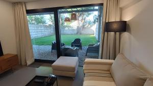 a living room with a couch and chairs and a window at Complejo "Casa Roca mdq" in Mar del Plata