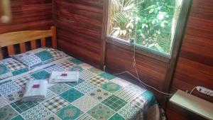 Una cama o camas en una habitación de Amazon Hostel & Eventos