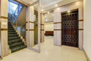 um corredor com uma porta e escadas com um espelho em Collection O Hotel Aaradhya Heritage em Bodh Gaya