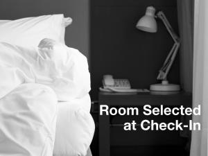 a bed with a room selected at check in at Metropolis Hotel in Athens