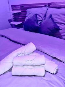 a bed with white sheets and pillows on it at Wander Saint Ouen in Saint-Ouen