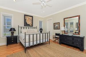 a bedroom with a bed and a mirror at Kevin's Heaven in Grayton Beach