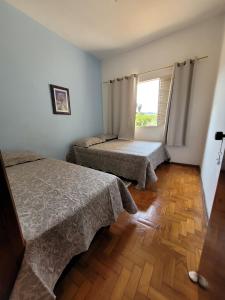 阿尤魯奧卡的住宿－Canto das Montanhas，一间卧室设有两张床和窗户。