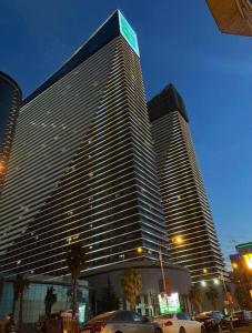 a large building with cars parked in front of it at Elite Class Sea View ApartHotel in Orbi city in Batumi