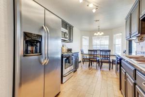 a kitchen with a stainless steel refrigerator and a dining room at Family-Friendly Ocean Springs Home Grill, Hot Tub in Ocean Springs