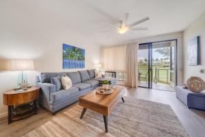 a living room with a couch and a table at Grand Champions 163 in Wailea
