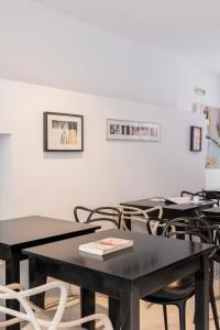 a group of tables and chairs in a room at Art Suites Athens in Athens