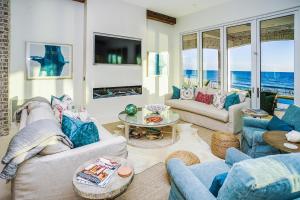 a living room with blue furniture and the ocean at 408 Blue Mountain in Santa Rosa Beach
