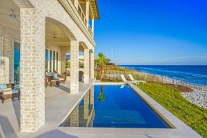 a house with a swimming pool next to the ocean at 408 Blue Mountain in Santa Rosa Beach