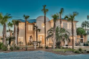 a large building with palm trees in front of it at 408 Blue Mountain in Santa Rosa Beach
