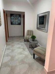 a hallway with two chairs and a table and a picture at Magnifique Appart OCEAN BLEU in Dakar