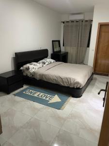 a bedroom with a bed and a rug on the floor at Magnifique Appart OCEAN BLEU in Dakar