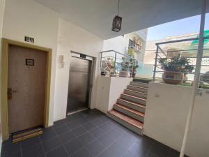 a hallway of a building with stairs and a door at Magnifique Appart OCEAN BLEU in Dakar