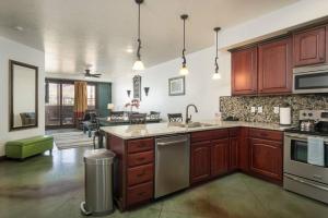 a kitchen with wooden cabinets and stainless steel appliances at Luxury Downtown Rental (Hot Tub/Pet Friendly) - La Dolce Vita Villas #11 in Moab