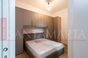 a small bedroom with a bed and cabinets at Porta Venezia New Luxury apt - wifi full equiped in Milan