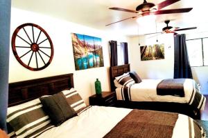 a bedroom with two beds and a wheel on the wall at River Retreat Cabin in Three Rivers - near SNP in Three Rivers