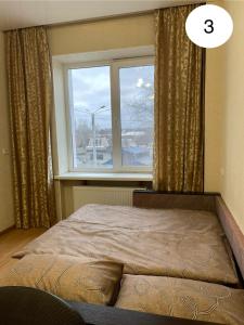 a bedroom with a bed and a window at Ideal KH apartments in Kharkiv