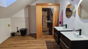 a bathroom with two sinks and a wooden cabinet at Christians Alpenparadies in Bad Mitterndorf