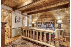 a bedroom with a bed in a room with wooden walls at Mountain Memories Is A Perfect Mountain Getaway For A Family Or Couples Retreat! in Sevierville