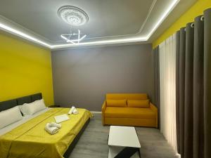 a small room with a bed and a couch at Algen Room's in Berat