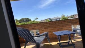 a pair of chairs and a table on a balcony at 3/17 Park Street in Port Macquarie