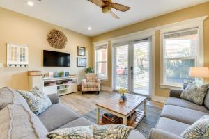 a living room with two couches and a tv at Bright and Modern Townhome Steps to Miramar Beach! in Destin