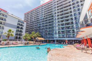 a swimming pool in front of a large building at Immaculate Ocean View Double Queen Suite! Beautifully Upgraded!-Grande Cayman Unit 316 in Myrtle Beach