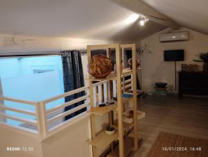 a room with a book shelf and a large window at Un nid sur les toits avec terrasse in Apt