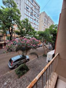 a balcony with a car parked on a street at Man's Place Hostel Masculino in Porto Alegre