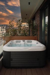 a large bath tub in a room with a window at 21st Century Zlatibor Residence, Spa & Wellness by Adora in Zlatibor