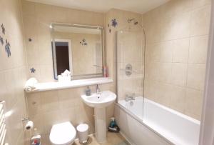 a bathroom with a sink and a toilet and a shower at Celaka Birmingham Central apartment in Birmingham