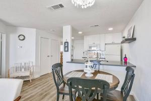 a kitchen and dining room with a table and chairs at Baca Beach Escape II in Galveston
