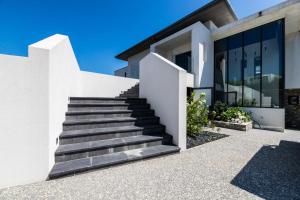 a white house with stairs in front of it at LAKEVIEW-KEYWEEK-villa Biarritz - Swimming pool in Biarritz