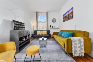 a living room with a yellow couch and yellow chairs at Central London Serviced Apartment - Paddington Luxury Stay - Hyde Park & Westminster in London