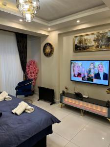 a bedroom with a tv on the wall and a bed at Deluxe suite golden horn in Istanbul