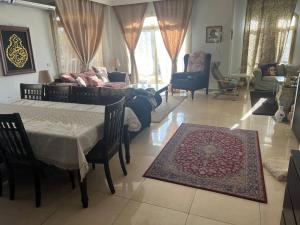 a living room with a couch and a table at 3 bedroom apt excellent location near to malls in Cairo +10 photos
