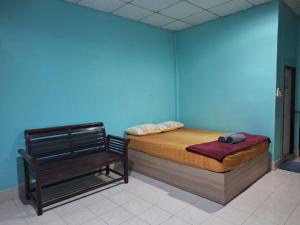 a blue room with a bed and a bench at Phonsomboon Guesthouse in Koh Tao