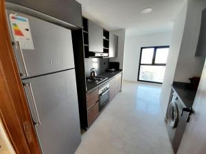 a kitchen with a stainless steel refrigerator and a stove at DOWNTOWN LIVING in Casablanca