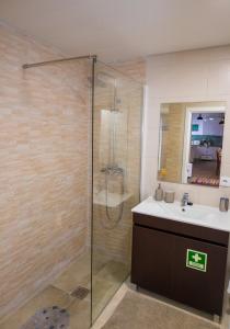 a bathroom with a shower and a sink at Casa da Abelheira in Ponta Delgada